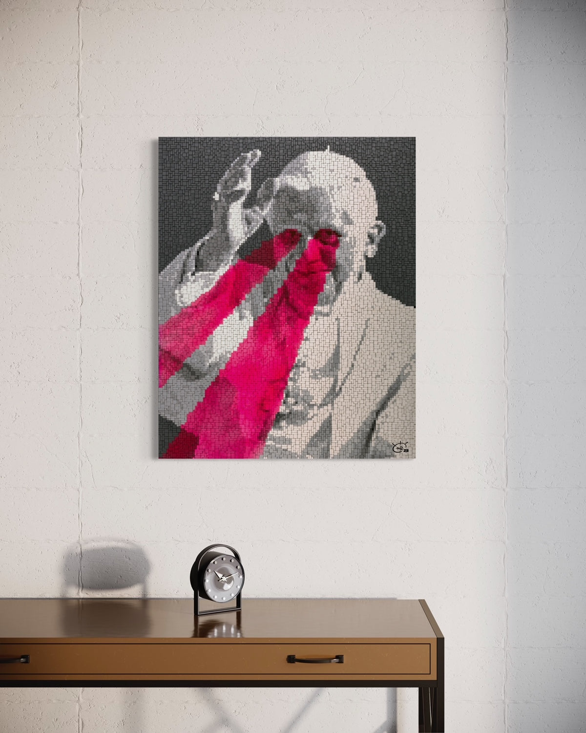 A pixel art canvas of the Pope with bright red laser eyes, displayed in a modern, minimalist room. The grayscale figure contrasts with the striking red laser beams in the artwork.
