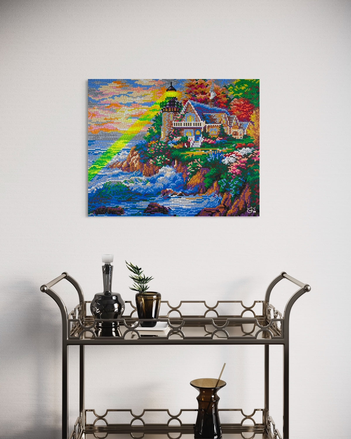 A vibrant pixel art canvas of a lighthouse with a green laser beam, displayed in a modern interior. The artwork showcases a scenic coastal landscape with a colorful sky and ocean waves.